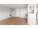 Living room featuring hardwood floors, staircase, and access to the kitchen at 13633 E Yale Ave # B, Aurora, CO 80014