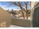 Outdoor patio view featuring large trees and townhouses at 13633 E Yale Ave # B, Aurora, CO 80014