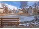 A quaint pond creates a tranquil setting within this community, complemented by a wooden fence and landscaping at 13633 E Yale Ave # B, Aurora, CO 80014