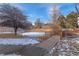 A frozen pond with pedestrian bridge enhances the community's charm, surrounded by mature trees and manicured grounds at 13633 E Yale Ave # B, Aurora, CO 80014