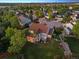 Beautiful home from above, nestled in a neighborhood with mature trees and well-maintained landscaping at 3566 E Meadow Creek Pl, Highlands Ranch, CO 80126