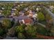 Aerial view showcases a home in a vibrant neighborhood with mature trees and well-maintained lawns at 3566 E Meadow Creek Pl, Highlands Ranch, CO 80126