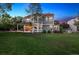 Beautiful backyard showing covered patio, lush lawn, and mature trees at 3566 E Meadow Creek Pl, Highlands Ranch, CO 80126