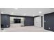 Finished basement with built-in shelving, a TV, and neutral carpet providing a versatile living space at 3566 E Meadow Creek Pl, Highlands Ranch, CO 80126