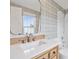 Bathroom featuring a vanity with a white countertop, wood cabinets, and a large mirror at 3566 E Meadow Creek Pl, Highlands Ranch, CO 80126
