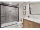This is a bathroom featuring a glass shower with vertical gray tiles, a marble countertop, and modern fixtures at 3566 E Meadow Creek Pl, Highlands Ranch, CO 80126