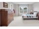 Bright bedroom with striped quilt, dresser, and large window view at 3566 E Meadow Creek Pl, Highlands Ranch, CO 80126