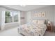 Cozy bedroom with colorful patchwork quilt, window view, and bright natural light at 3566 E Meadow Creek Pl, Highlands Ranch, CO 80126