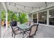 Relaxing covered patio with outdoor dining set, barbecue, and string lights for evening ambiance at 3566 E Meadow Creek Pl, Highlands Ranch, CO 80126