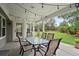 Inviting covered patio with string lights, comfortable seating, and a view of the landscaped yard at 3566 E Meadow Creek Pl, Highlands Ranch, CO 80126