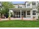 Covered patio with dining table and potted flowers offering a cozy outdoor living space at 3566 E Meadow Creek Pl, Highlands Ranch, CO 80126