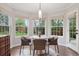 Bright breakfast nook with a round table, stylish chairs, large windows, and a view of the backyard at 3566 E Meadow Creek Pl, Highlands Ranch, CO 80126