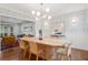 Elegant dining room with designer wallpaper, a modern chandelier, and views into the adjacent living room at 3566 E Meadow Creek Pl, Highlands Ranch, CO 80126