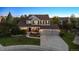 Two-story home with a large front yard, a well-manicured lawn, and a three-car garage at 3566 E Meadow Creek Pl, Highlands Ranch, CO 80126