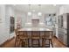 Modern kitchen with white cabinetry, stainless steel appliances, a center island with bar seating, and wood floors at 3566 E Meadow Creek Pl, Highlands Ranch, CO 80126