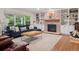 Cozy living room with built-in shelves, fireplace, comfortable seating, and large windows offering great natural light at 3566 E Meadow Creek Pl, Highlands Ranch, CO 80126