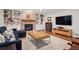 Cozy living room showcasing brick fireplace, built-in shelves, and comfortable seating at 3566 E Meadow Creek Pl, Highlands Ranch, CO 80126