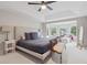 Spacious primary bedroom with a tray ceiling, ceiling fan, sitting area, and ample natural light at 3566 E Meadow Creek Pl, Highlands Ranch, CO 80126