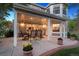 Inviting covered patio with string lights, dining table, and beautiful outdoor seating area at 3566 E Meadow Creek Pl, Highlands Ranch, CO 80126