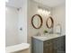 Bathroom featuring double sinks, updated fixtures, granite counters, and a walk-in shower at 2784 E Maplewood Ave, Centennial, CO 80121