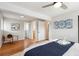 Bright main bedroom featuring hardwood floors and a view into a walk-in closet and the en-suite at 2784 E Maplewood Ave, Centennial, CO 80121