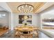 Dining room with a wood table, chandelier, and large windows with views of the outside at 2784 E Maplewood Ave, Centennial, CO 80121