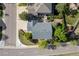 Aerial view showcases a home's roof, landscaped yard, and surrounding neighborhood streets at 4290 S Deframe St, Morrison, CO 80465