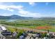 Scenic aerial view of the community with open trails, a lake, and mountain views in the distance at 4290 S Deframe St, Morrison, CO 80465