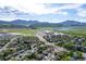 Breathtaking aerial view of the neighborhood showcasing the homes, nearby shopping centers, and mountain views at 4290 S Deframe St, Morrison, CO 80465