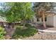 Landscaped backyard featuring a well-maintained lawn, mature trees, and an outdoor seating area at 4290 S Deframe St, Morrison, CO 80465