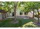 Relaxing backyard featuring a cozy deck with outdoor seating surrounded by lush trees and a well-maintained lawn at 4290 S Deframe St, Morrison, CO 80465
