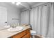 Bathroom with a sink, vanity, toilet, and shower with a curtain at 4290 S Deframe St, Morrison, CO 80465