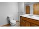 Bathroom featuring a toilet, sink, vanity, and medicine cabinet at 4290 S Deframe St, Morrison, CO 80465