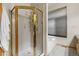 Bright bathroom with a glass-enclosed shower, a tub, and a large window providing natural light at 4290 S Deframe St, Morrison, CO 80465