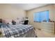 Bedroom with a bed, desk, dresser, and a window with blinds at 4290 S Deframe St, Morrison, CO 80465