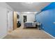 Bedroom with a blue accent wall and an open door to a closet at 4290 S Deframe St, Morrison, CO 80465
