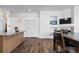 Bright dining area featuring wood floors, modern lighting and built-in shelving near the TV and dining table at 4290 S Deframe St, Morrison, CO 80465