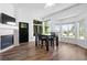 Bright dining area featuring a modern fireplace, large windows, and a dark wood table at 4290 S Deframe St, Morrison, CO 80465