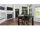 Cozy dining area featuring a modern fireplace, large windows, and a dark wood table at 4290 S Deframe St, Morrison, CO 80465