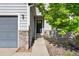 Welcoming front entrance showcasing stone accents, a dark front door, and a well-maintained walkway at 4290 S Deframe St, Morrison, CO 80465