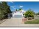 Charming home with a three-car garage and manicured lawn under a sunny sky at 4290 S Deframe St, Morrison, CO 80465