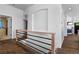 Bright hallway showcasing a modern railing, light walls, and access to various rooms at 4290 S Deframe St, Morrison, CO 80465