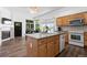 Charming kitchen features an island sink, ample cabinet space, and windows that provide natural light and a view at 4290 S Deframe St, Morrison, CO 80465