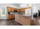 Cozy kitchen with wooden cabinets, center island, modern appliances, and an adjacent living space at 4290 S Deframe St, Morrison, CO 80465