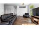 Bright living room with hardwood floors and a comfortable leather sofa at 4290 S Deframe St, Morrison, CO 80465