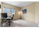 This is an office featuring carpet flooring, a modern desk setup, and a large window for natural light at 4290 S Deframe St, Morrison, CO 80465