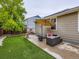 Backyard featuring artificial turf, a fire pit, and a seating area, designed for outdoor relaxation and entertaining at 426 N 48Th Ave, Brighton, CO 80601