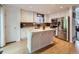 Bright kitchen featuring an island with a marble countertop, white cabinetry, and stainless steel appliances at 426 N 48Th Ave, Brighton, CO 80601