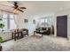 Welcoming living room with large windows, a ceiling fan, and plush carpet, creating a comfortable space at 426 N 48Th Ave, Brighton, CO 80601