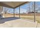 Covered patio area overlooking a grass backyard with a wooden fence at 2172 S Harlan St, Denver, CO 80227